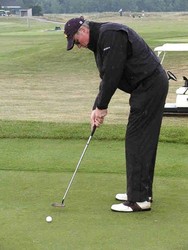 Brian Judge putts in his new all-weather outfit